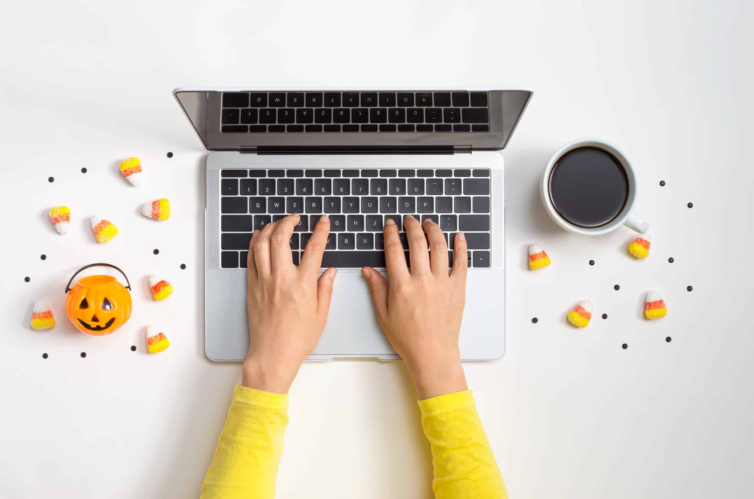 Halloween theme with person using a laptop computer